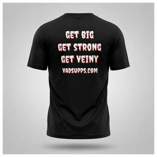 A black short-sleeve t-shirt shown from the back, featuring the slogan 'GET BIG GET STRONG GET VEINY' and the website 'VADSUPPS.COM' printed in a white distressed font with a red shadow effect, set against a light gray background.